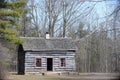 Small rustic wood cottage among pine trees in Ontario forest Royalty Free Stock Photo