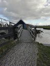 Small rustic wooden bridge over the river in Kinderdijk Royalty Free Stock Photo