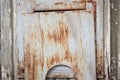 Small rusty hatch in door