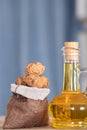 Small sacks filled with walnuts and a bottle of walnut oil