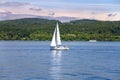 Small sail boat on lake on sunny day