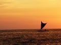 Small sail boat silhouette sailing background burnt orange sunset Royalty Free Stock Photo