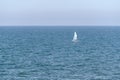 Small sailboat on calm sea water