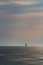 Small sailboat float on Croatia sea with cloudy sky. Long exposure, motion blur, minimalism photo