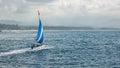 Small sailboat floats on water with amazing mountain views