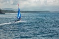 Small sailboat floats on water with amazing mountain views