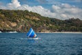 Small sailboat floats on water with amazing mountain views