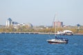 Small sailboat on the Hudson River near New York with bright azure water under a pale sky