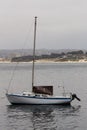 Small Sailboat Moored In Monterey Bay With Beach And Hills Royalty Free Stock Photo