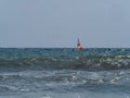 Small sailing boat in the waves of the rough sea