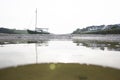 A small sailing boat sitting on the sand bank of the river Gannel, in Cornwall