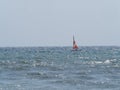 Small sailing boat in the waves of the rough sea