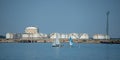 small sailing boats on the river on the background of factories