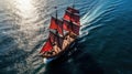 Crimson Tide. Small sailing ship in the open sea at sunset.