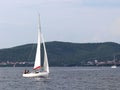 A small sailing sports yacht of daytime sailing is sailing with three yachtsmen along the coast of Croatia. Water sports and summe Royalty Free Stock Photo