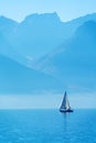 A small sailing yacht on the Lake Geneva and the Alps, Switzerland Royalty Free Stock Photo