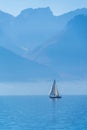 A small sailing yacht on the Lake Geneva and the Alps, Switzerland Royalty Free Stock Photo