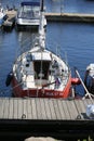 Small sailing yacht moored stern to the pier