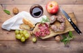 Small salami, bread, grapes, apple, walnuts and red wine. Top view Royalty Free Stock Photo
