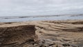 Small sand walls created due to soil erosion by streams of rain water on the beach Royalty Free Stock Photo