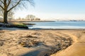 Small sandy beach along a wide Dutch river in wintertime Royalty Free Stock Photo