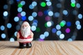 Small Santa Claus on wooden table with bright background. Minimal Christmas or New Year concept Royalty Free Stock Photo