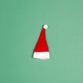 Small santa hat on green background