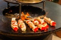 Small satay on wooden skewers fried on a brazier close up