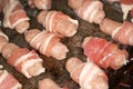 Small sausages wrapped with bacon ready to cook.