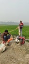 Small scale farmer watering his field