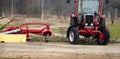 Small scale farming with tractor and plow in field Royalty Free Stock Photo