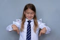 Small schoolgirl pointing down portrait