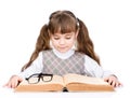 Small schoolgirl reading big book. isolated on white background Royalty Free Stock Photo