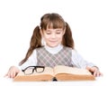 Small schoolgirl reading big book. isolated on white background Royalty Free Stock Photo