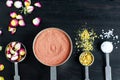 Small scoops with moroccan red clay, dry rose buds, marigold flowers and dead sea salt. Ingredients for preparing diy masks. Royalty Free Stock Photo