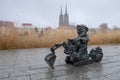 Small sculpture of bronze gnome on digger on Odra River embarkment. Wroclaw. Poland