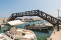 Small sea port with moored fishing boats under the bridge on Rhodes island, Greece