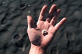 Small sea snail in the palm of a young hand