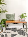 Small seating nook in Scandinavian design with lots of natural bright light and green houseplants creating a jungle feeling