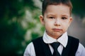 Small serious clever boy wear suit