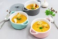 Small serving pots or bowls with cream soup made of red lentils with rusks, spices and herbs parsley, coriander Royalty Free Stock Photo