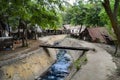 Small sewage canal surmounted by a bridge