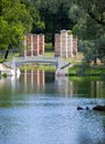 The small shabby bridge in park over a pond. Gatchina. Petersburg. Russia.