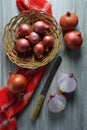 Shallots onions, a knife and a red kitchen towel Royalty Free Stock Photo