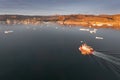 Small ship cruising among ice bergs during beautiful summer day. Disko Bay, Greenland. Royalty Free Stock Photo
