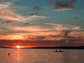 Small ship sailing at sundown