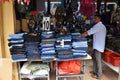 Small shop owner indian man selling shawls, clothing and souvenirs at his store Royalty Free Stock Photo