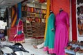 Small shop owner indian man selling shawls, clothing and souvenirs at his store. Colorful traditional Indian costume/outfit for Royalty Free Stock Photo