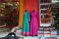 Small shop owner indian man selling shawls, clothing and souvenirs at his store. Colorful traditional Indian costume/outfit for Royalty Free Stock Photo