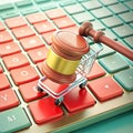 Miniature Shopping Cart with Gavel on a Keyboard with Red and Green Keys Representing Digital Commerce Law Royalty Free Stock Photo